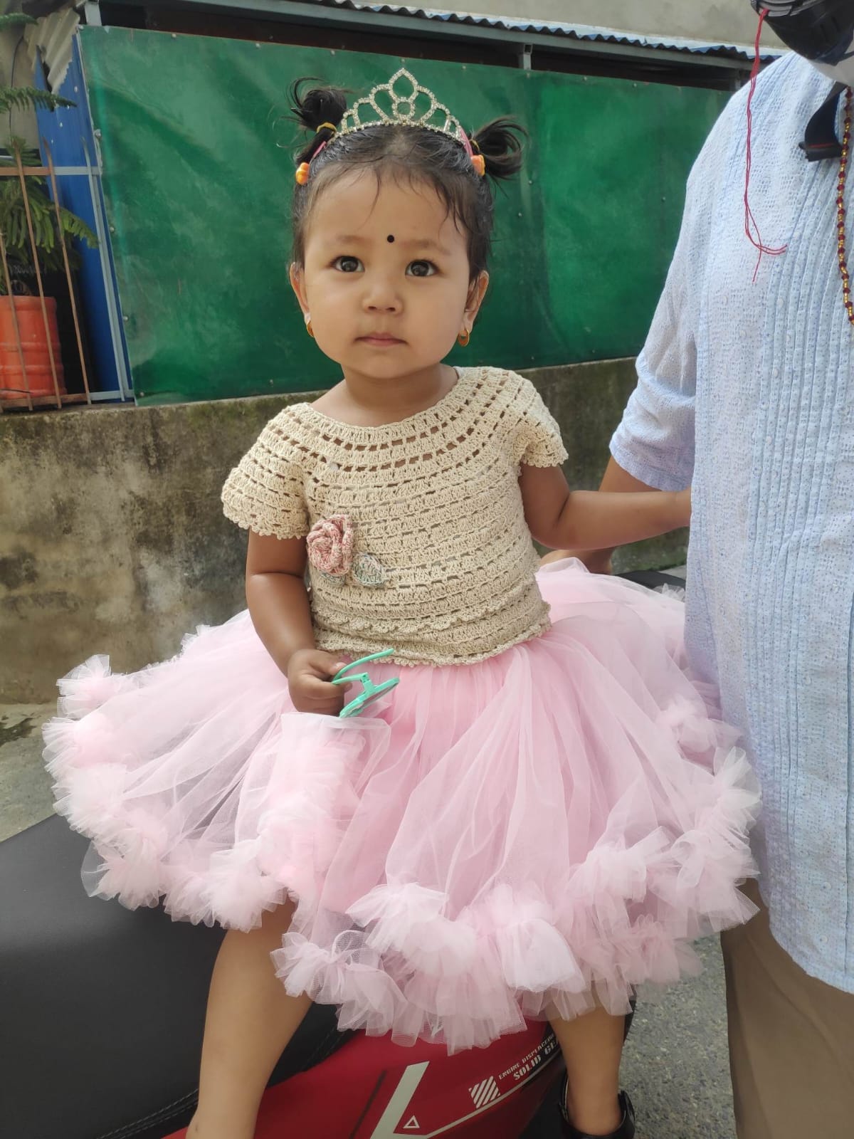Our littlest model in a cream crochet top with a crochet rose